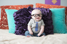 infant boy wearing a tie t-shirt and glasses