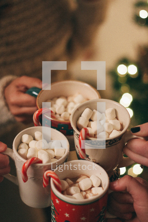 mugs of hot cocoa and candy canes 