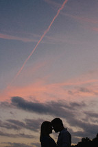 silhouettes of a couple about to kiss