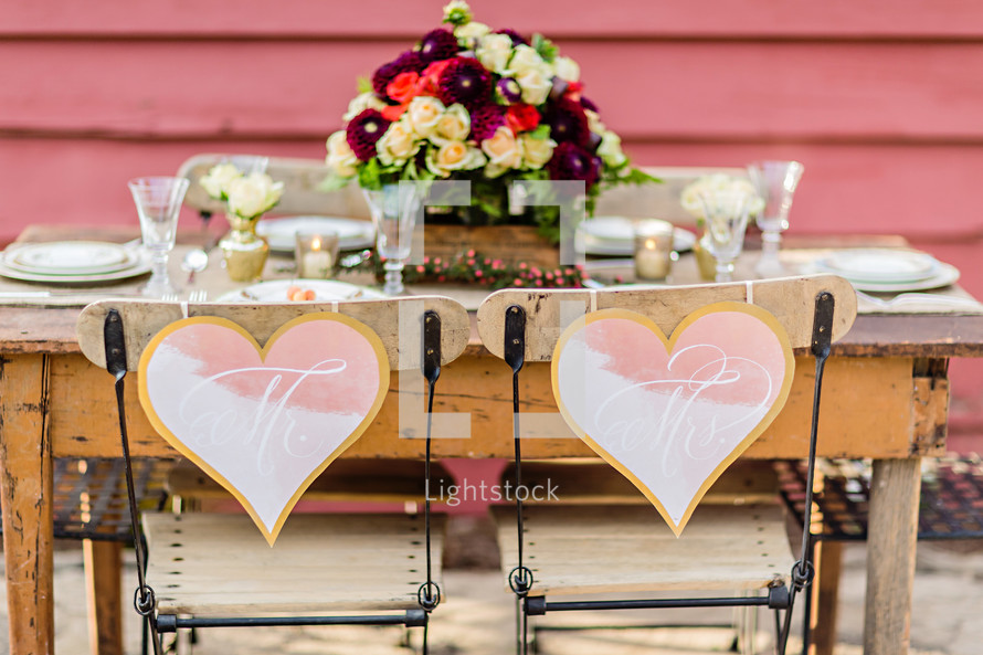 A rustic  table setting for a bride and groom wedding decor table setting hearts