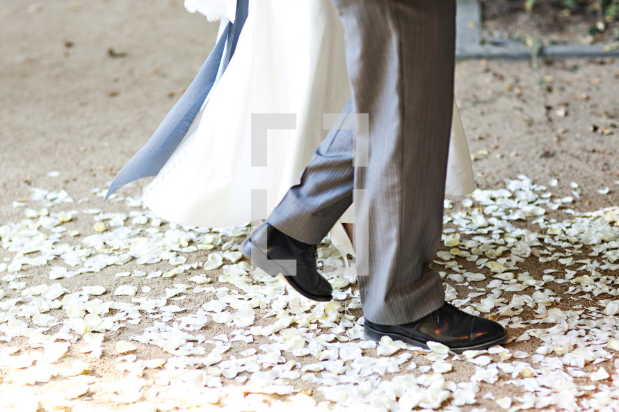 Bride and groom walking on flower petals wedding isle I do marriage relationship together