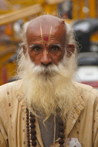 Elderly Hindu man from the Bendiwali sect, southern India, with long white beard and prayer beads around his neck. 
