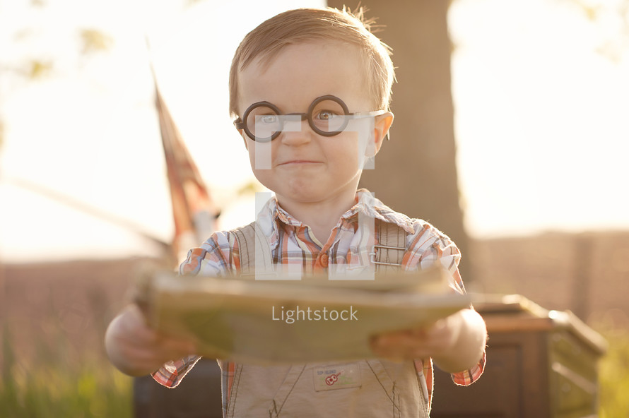 A little boy wearing glasses
