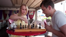 Smiling couple playing a game of chess