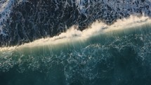 Aerial view of the Atlantic Ocean with waves crashing to the shore.