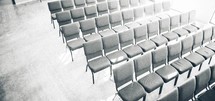 empty rows of chairs in a church