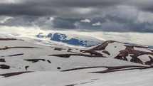 Dramatic clouds moving over winter volcanic mountains of Katla in Iceland. Time lapse Zoom in
