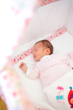newborn baby girl in a crib 