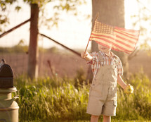 toddler boy waving an American flag