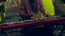a man playing a keyboard on stage 