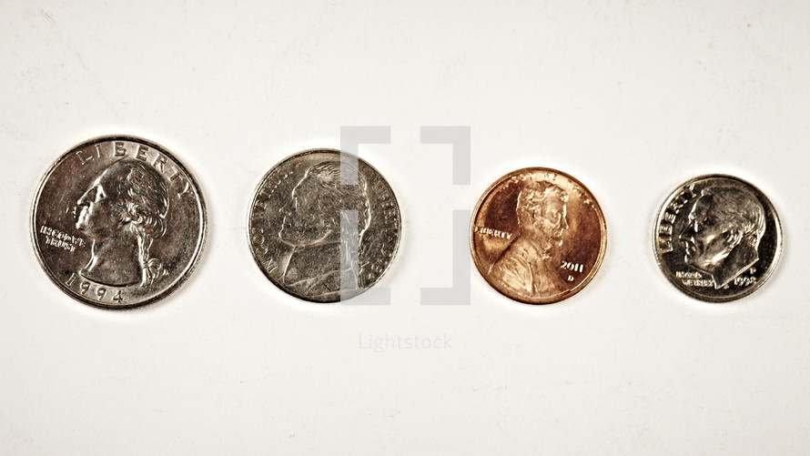 A quarter, nickel, penny and dime isolated on white