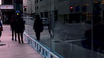 pedestrians walking on a city sidewalk 