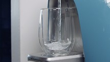 Close up Slow motion of a water cup filling in a water filtering machine