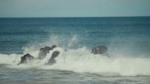 waves crashing into a rock 