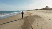 Determined Man Runs On The Beach To Achieve His Goals