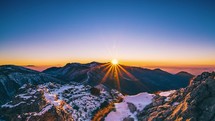 Colorful sunset in winter alpine mountains with golden sunstar reflection in magic evening Tourism background Time lapse
