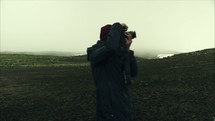 woman with a camera taking pictures in Iceland and view from a drone 