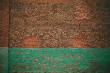 Brick wall with turquoise paint strip