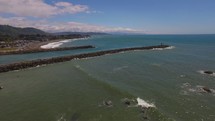 Aerial Video 180 Degree Pan of Pacific Ocean and Beachfront Town