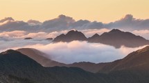 Epic misty clouds moving over alpine mountains in peaceful evening nature Time-lapse
