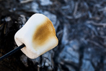 Roasted marshmallow on a skewer.