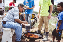 men cooking food outdoors in Mexico 