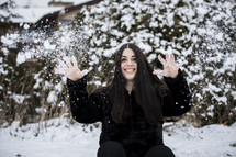 a woman throwing snow 