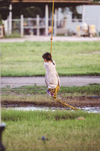 a child swinging on a rope swing 