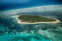 aerial view over an island and Great Barrier reef