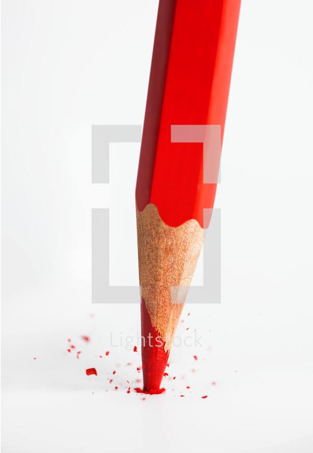 Broken tip of red pencil isolated on white background.