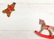 Christmas Decorations with Gingerbread man on white wooden background with copy space.