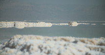 Slow pan of salt deposits on the banks of the Dead Sea in Israel. 