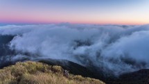 Magic morning above foggy clouds moving in valley in New Zealand mountains nature Time-lapse
