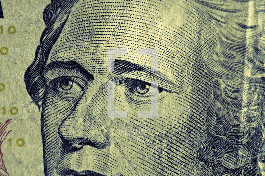 A close up view of Alexander Hamilton on a ten dollar bill