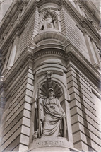 statues at the corner of a building 