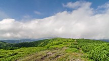 Clouds motion over green Carpathian mountains ridge in sunny summer nature time-lapse
