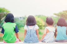 group of little girls hanging out in a park in summer 
