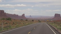 Driving to Monument Valley, Towering Sandstone Buttes on Navajo Tribal on Arizona - Utah Border USA