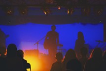 silhouette of a musician on stage