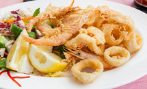 Fried shrimp and squid with lemon, italian food.