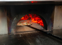 pizza cooking in a brick oven 