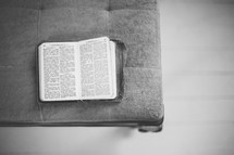 an open Bible on a chair 