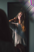 teen girl looking in a mirror 