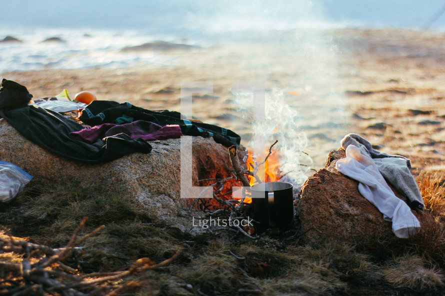 drying clothes by a campfire 