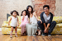 Asian family sitting on a couch 