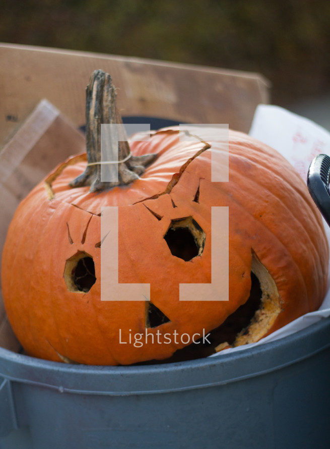 jack-o-lantern in a trash can 