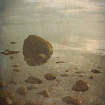 rocky shore at sunrise - vintage textured