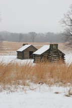 Valley Forge log cabins in the snow