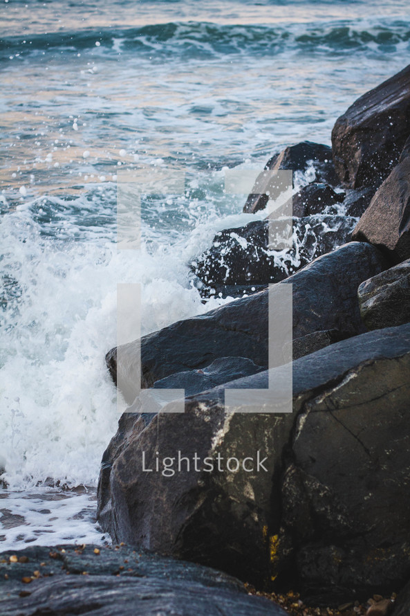 ocean water crashing into rocks 