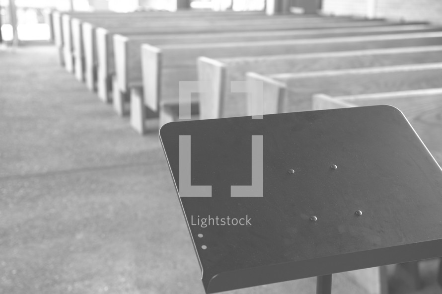 music stand and rows of church pews 